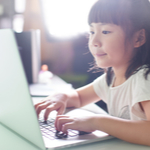 kid playing on laptop